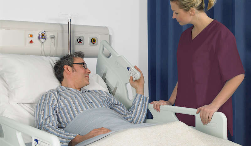 Arjo Enterprise 8000X Nurse and patient Main Image 1 8000x467_Product_Page_Main_Image