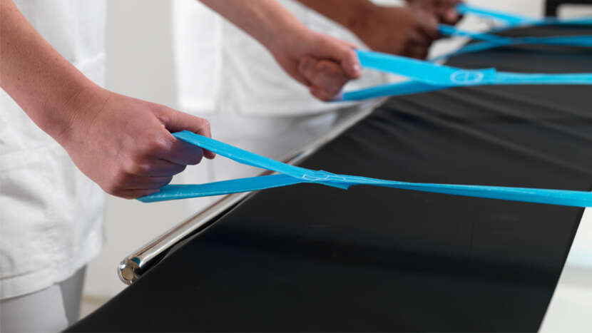 ArjoHuntleigh-Sliding-Aids-Maxi-Slide-Flites-Hands-pulling-on-straps-close-up.png_Product_Page_Main_Image