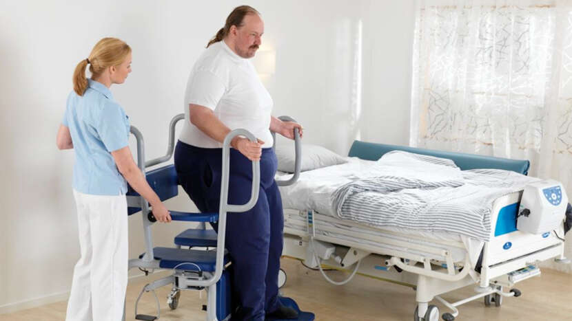 ArjoHuntleigh-hygiene-systems-shower-chairs-caregiver-with-patient-on-Carmina_Product_Page_Main_Image